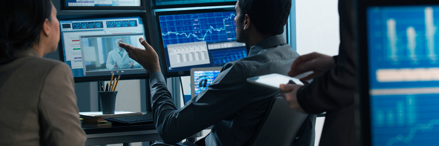 Business people working in video conference while reviewing stocks