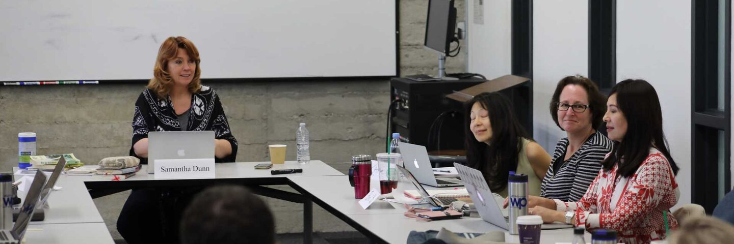 Writers collaborating at a round table.
