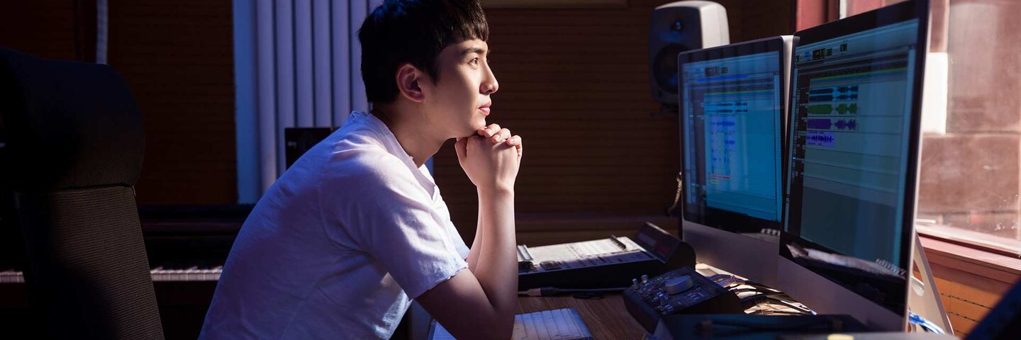 Man working at mixing panel in a recording studio