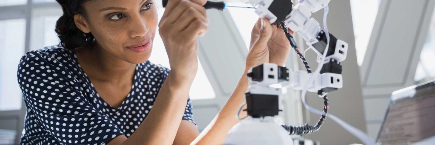 Female engineer working on robotics.