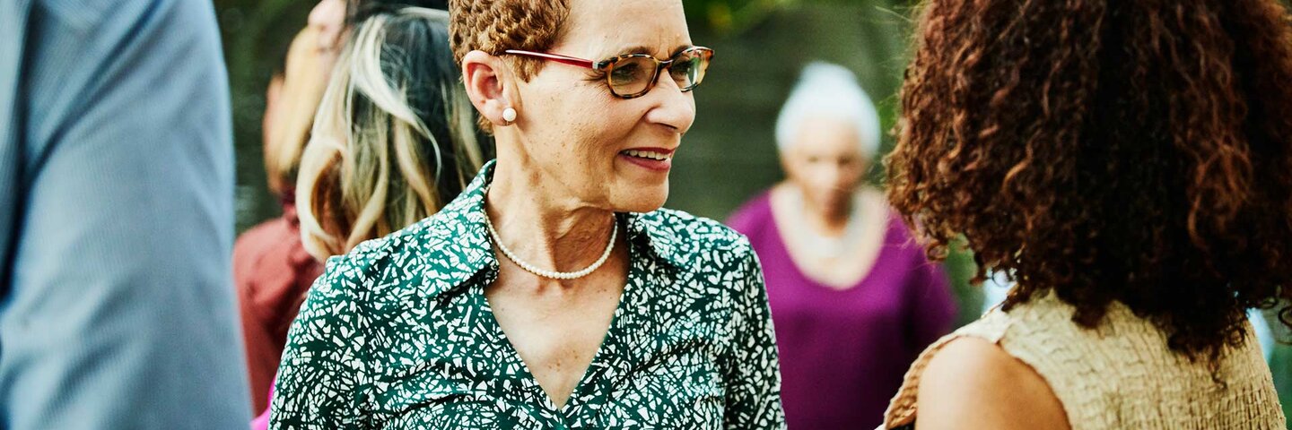 Smiling woman in discussion with another woman