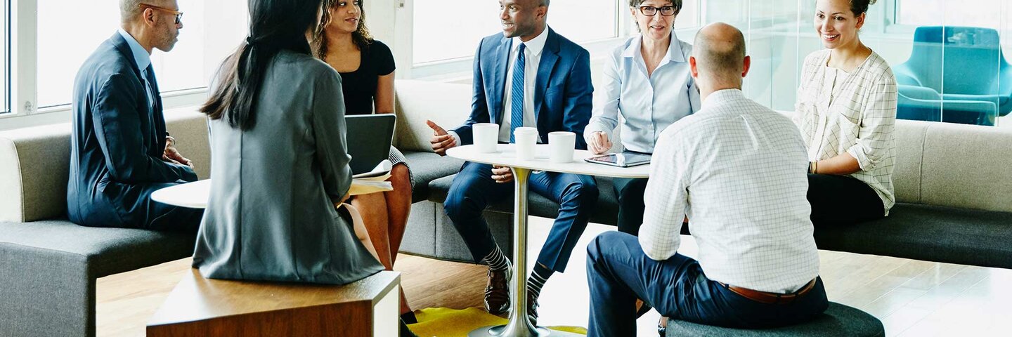 Group of businesspeople in discussion during project meeting in office