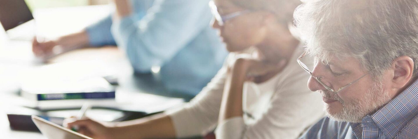 Students studying in adult education classroom