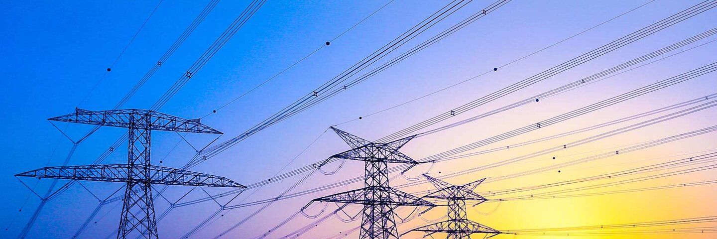 Electrical Pylons against vibrant twilight colors and a gorgeous sunset
