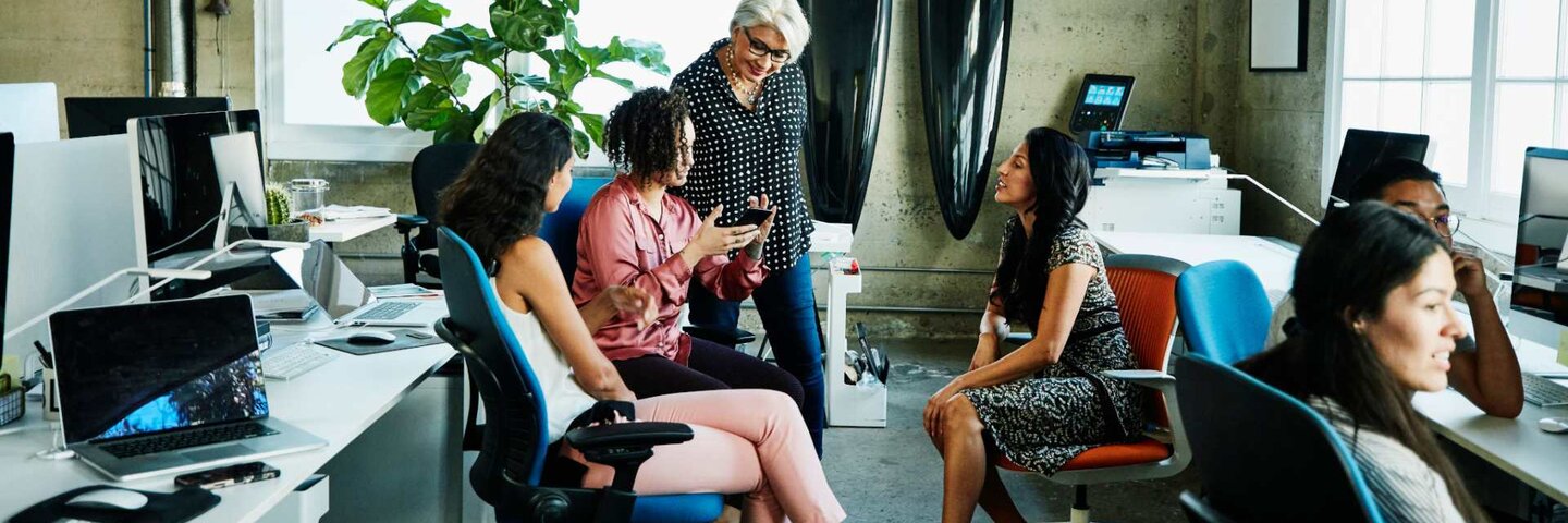 Professionals meeting around workstations