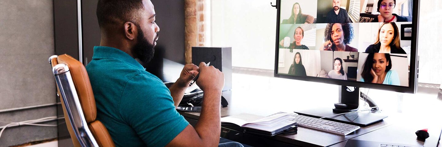 Mid adult manager video conferences with his team