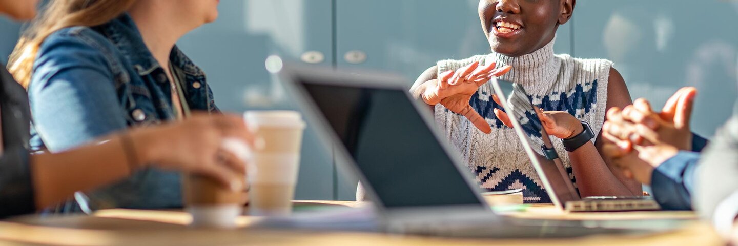 students smiling around a table