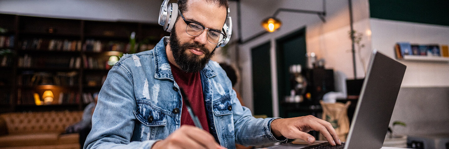 writer working on laptop and notepad