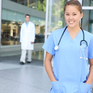 female medical professional smilling in scrubs