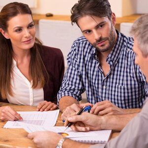 three people sitting and consulting