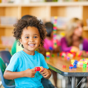 young child playing with legos